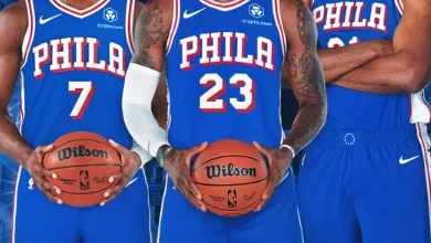 "LeBron James poses in a Philadelphia 76ers jersey after signing with the team in 2026"